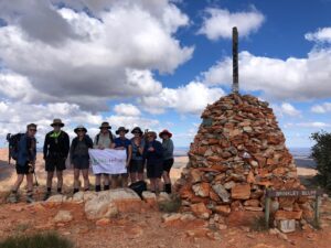 hikers on top of a mountain on the Larapinta Trail